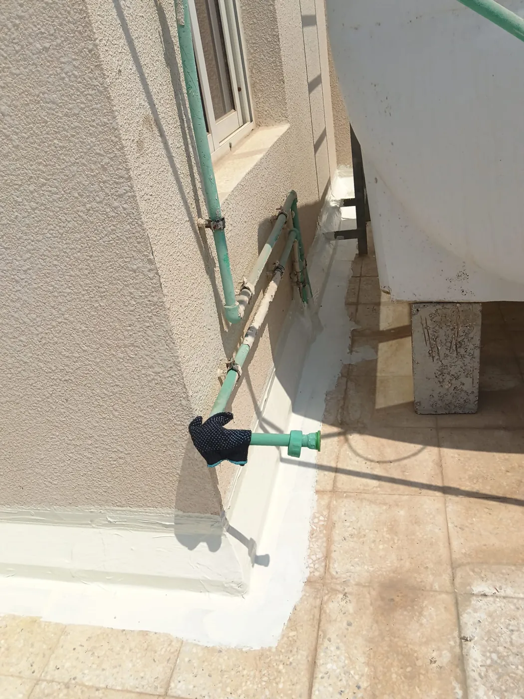 Detailing: Upstands and pipe penetrations treated before the main coat.